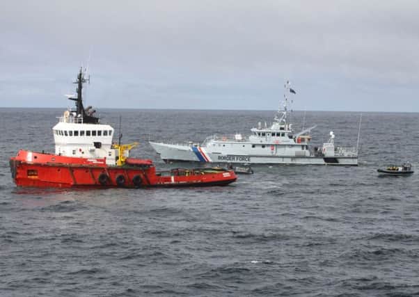 The tugboat, left, is intercepted by the Border Force vessel Valiant. Picture: Getty