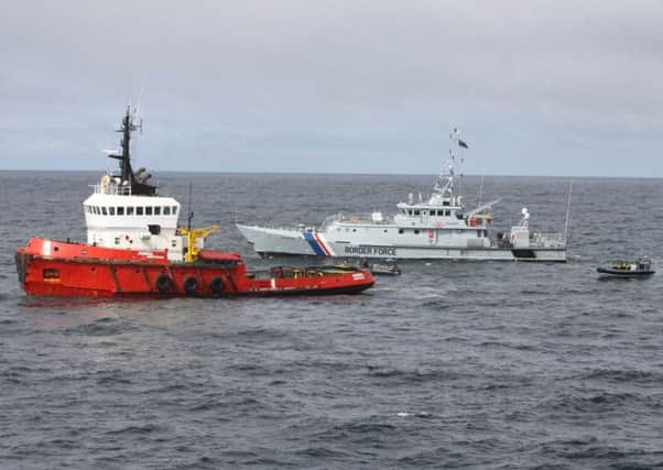 The tugboat, left, is intercepted by the Border Force vessel Valiant. Picture: Getty