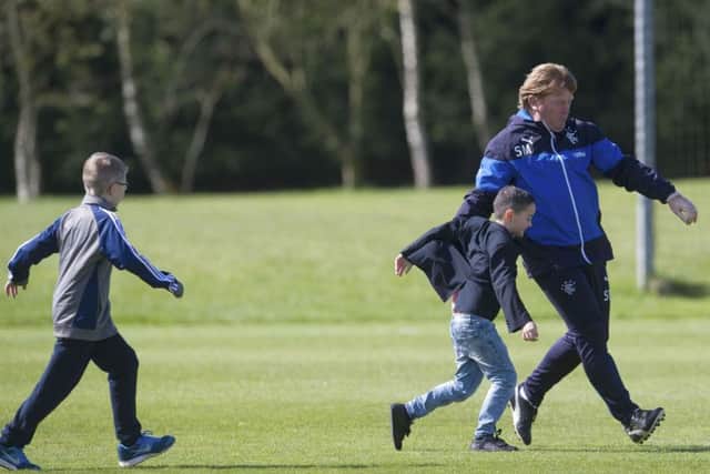 Rangers manager Stuart McCall takes on some young supporters during training at Murray Park. Picture: SNS