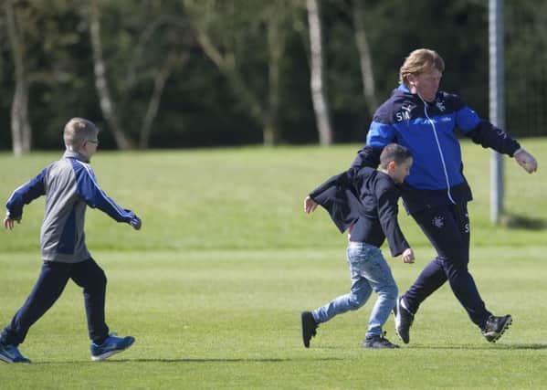 Rangers manager Stuart McCall takes on some young supporters during training at Murray Park. Picture: SNS