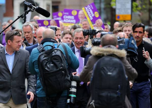 Ukip leader Nigel Farage is surrounded media and supporters during a visit to Aylesbury in Buckinghamshire. Picture: PA