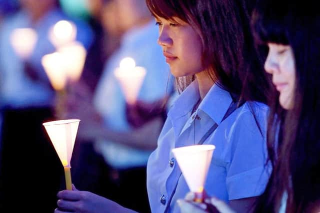 Thai students at a university in Bangkok remember the victims. Picture: AFP/Getty
