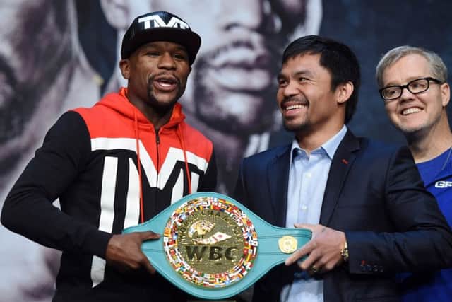 Floyd Mayweather, left, and Manny Pacquiao pose with a WBC championship belt at the MGM Grand in Las Vegas. Picture: Getty