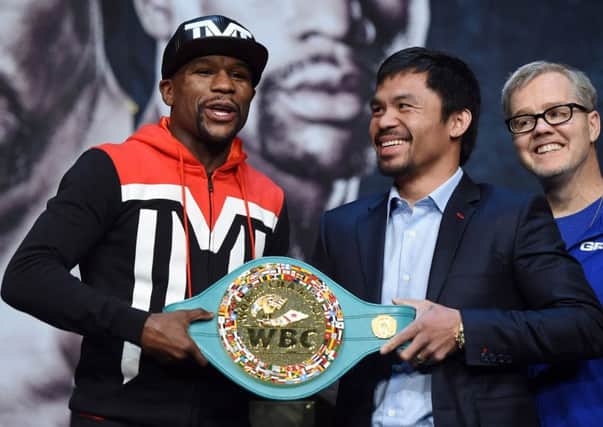 Floyd Mayweather, left, and Manny Pacquiao pose with a WBC championship belt at the MGM Grand in Las Vegas. Picture: Getty