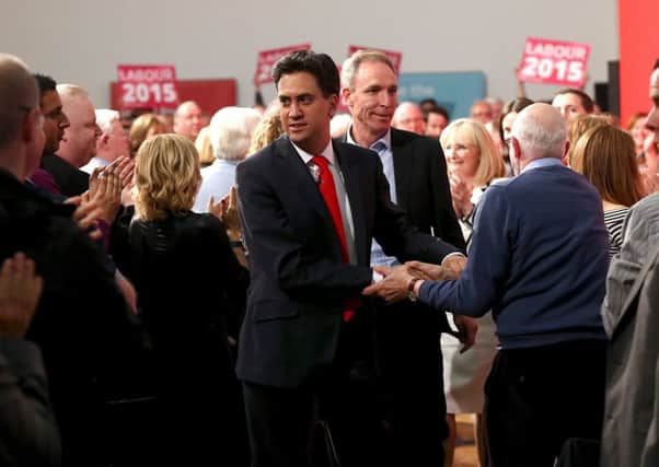 Ed Miliband and Jim Murphy acknowledge supporters in the Glasgow East constituency last night. Picture: Getty