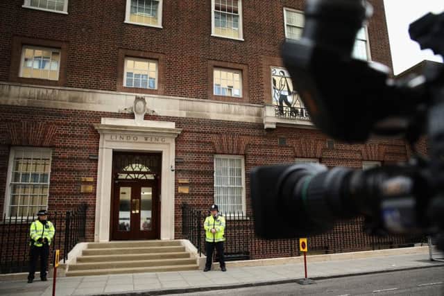 Policemen wait outside the Lindo Wing of St Mary's Hospital in London. Picture: Getty