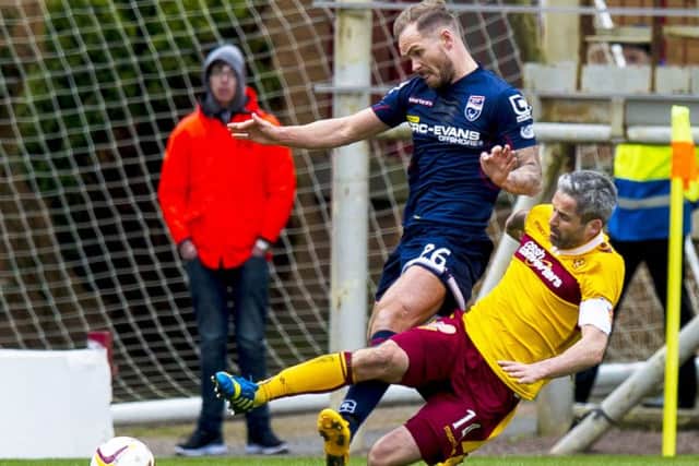 Motherwell's Keith Lasley (right) battles for the ball with Martin Woods. Picture: SNS Group