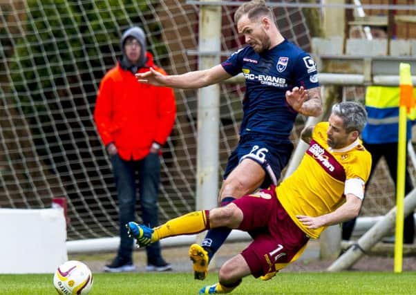 Motherwell's Keith Lasley (right) battles for the ball with Martin Woods. Picture: SNS Group