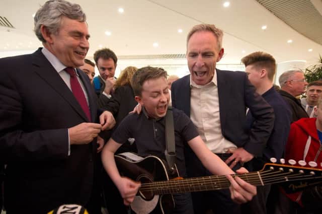 Scottish Labour leader Jim Murphy sings with Mathew Gibb as Gordon Brown looks on at Braehead Shopping Centre. Picture: PA