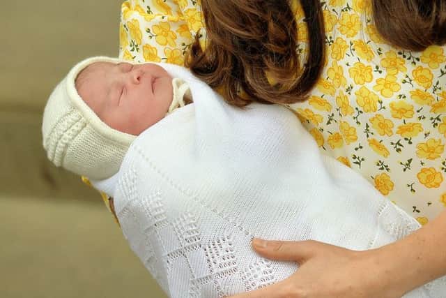 The Princess of Cambridge in the arms of her mother. Picture: PA