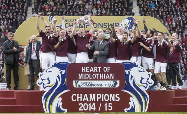 Hearts captain Danny Wilson lifts the Scottish Championship trophy at Tynecastle. Picture: PA