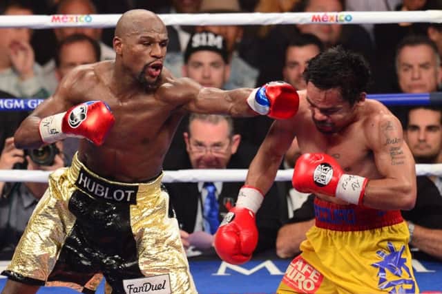 Floyd Mayweather lands another punch on Manny Pacquiao. Picture: Getty