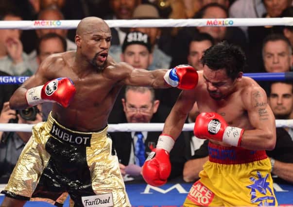 Floyd Mayweather lands another punch on Manny Pacquiao. Picture: Getty