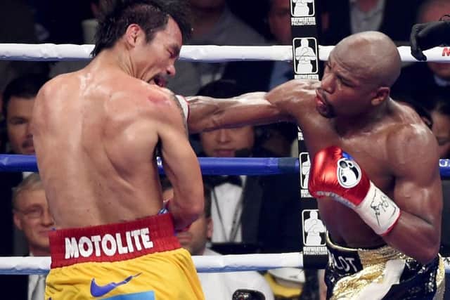 Mayweather unleashes a right to the chin of Pacquiao. Picture: Getty