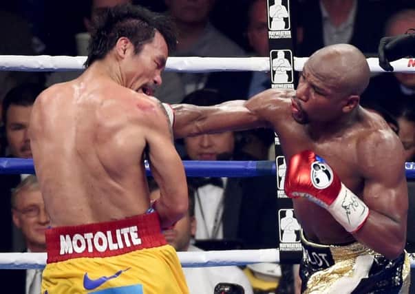 Mayweather unleashes a right to the chin of Pacquiao. Picture: Getty