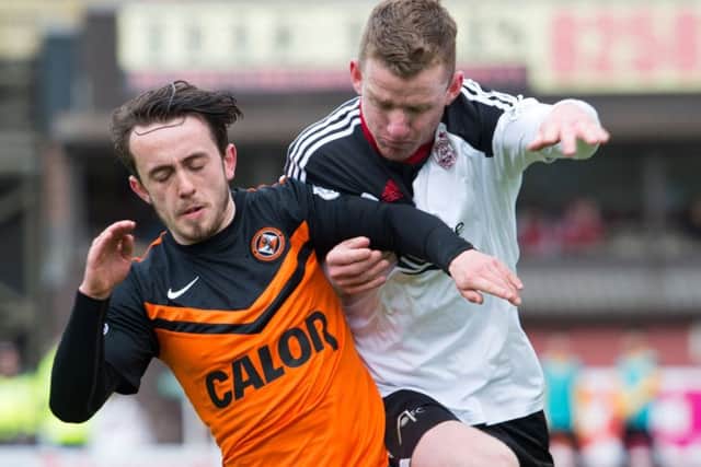 Dundee Uniteds Aidan Connolly attempts to shake off a challenge from Jonny Hayes. Picture: SNS