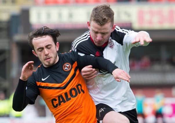 Dundee Uniteds Aidan Connolly attempts to shake off a challenge from Jonny Hayes. Picture: SNS