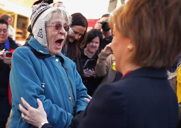 Nicola Sturgeon greets an enthusiastic SNP supporter while campaigning on the streets of Kirkcaldy yesterday. Picture: Getty