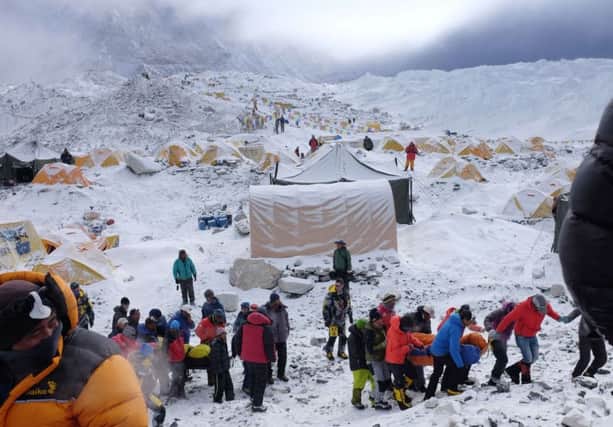 Rescuers carry the injured from base camp after the Everest avalanches. Picture: AFP/Getty