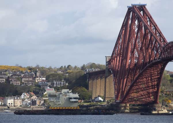 The bridge of HMS Prince of Wales passing under the Forth Bridge as it is delivered to Rosyth for assembly. Picture: PA