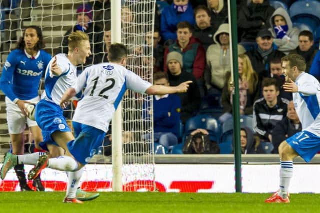 Aidan Smith celebrates with Queen of the South team-mates after scoring the equaliser in a 1-1 draw at Ibrox in March. Picture:SNS