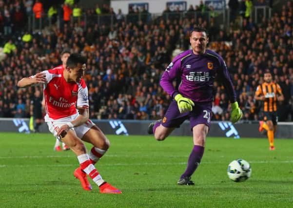 Arsenal's Chilean striker Alexis Sanchez rounds Steve Harper to score his second goal. Picture: Getty
