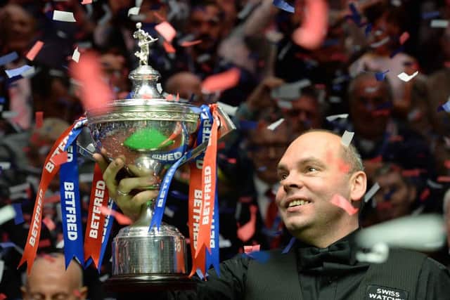 Stuart Bringham with the world trophy on Monday night. Picture: PA