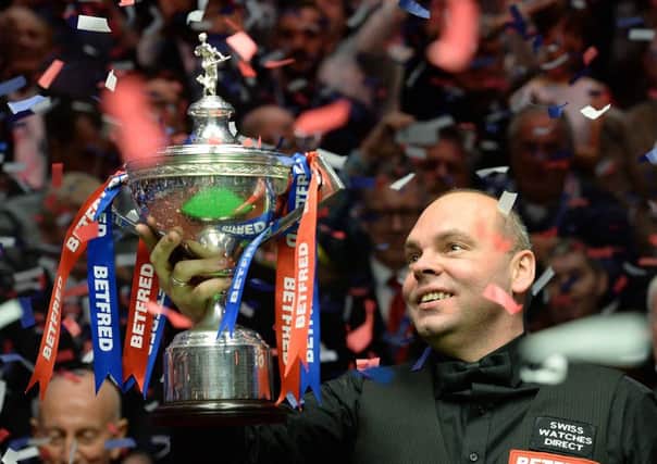 Stuart Bringham with the world trophy on Monday night. Picture: PA