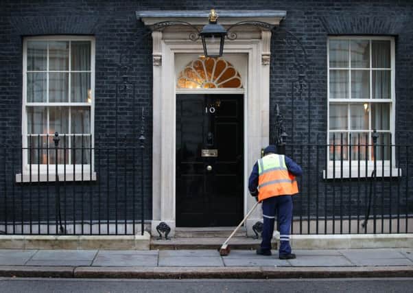 A street cleaner works outside Number 10 Downing Street. Picture: Getty
