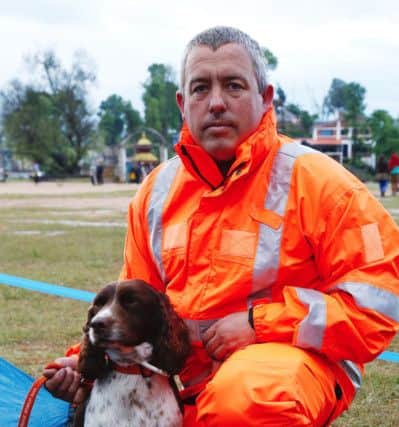 Scottish firefighter Gary Carroll with his search dog Diesel. Picture: PA