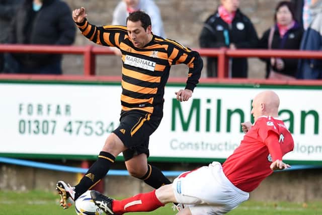 Brechin's Gerry McLauchlan slides in on Alloa's Michael Chopra. Picture: SNS