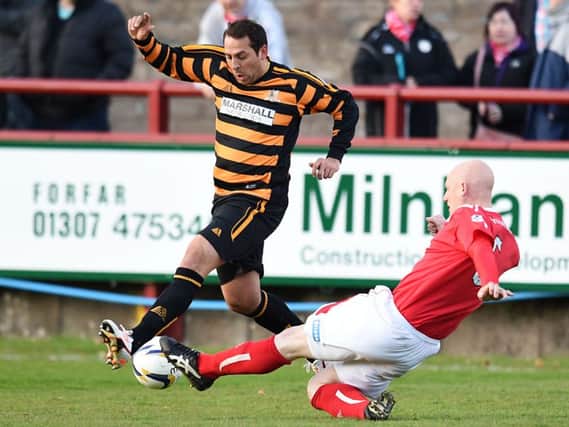 Brechin's Gerry McLauchlan slides in on Alloa's Michael Chopra. Picture: SNS