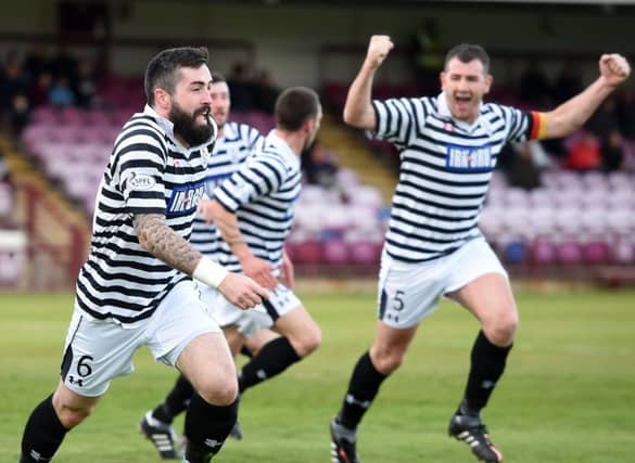 Queens Park's Bryan Wharton (left) wheels away in delight having put his side 1-0 to the good. Picture: SNS