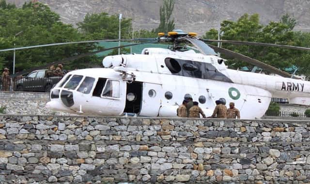 Soldiers gather beside an army helicopter at a military hospital in Gilgit where victims of a helicopter crash were taken. Picture: Getty