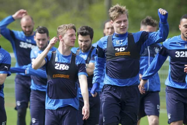 Rangers players Tom Walsh, left, and Marius Zaliukas stretch off in training at Murray Park. Picture: SNS