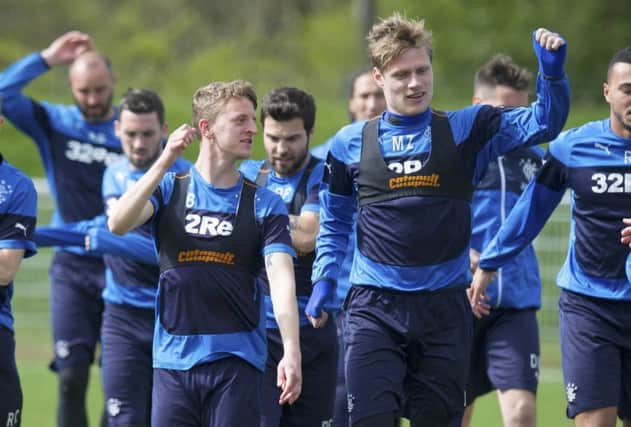 Rangers players Tom Walsh, left, and Marius Zaliukas stretch off in training at Murray Park. Picture: SNS
