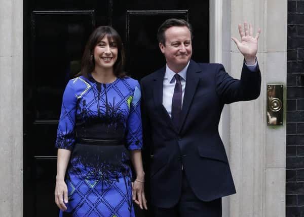 David Cameron (R) and his wife Samantha are all smiles after the general election result. Picture: AFP
