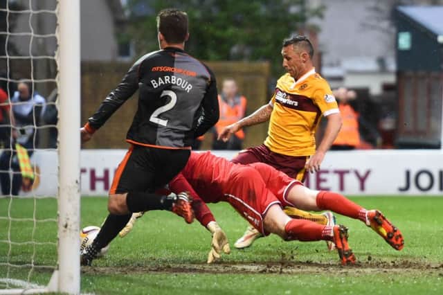 Scott McDonald nudges the ball over the line to open the scoring at Fir Park. Picture: SNS