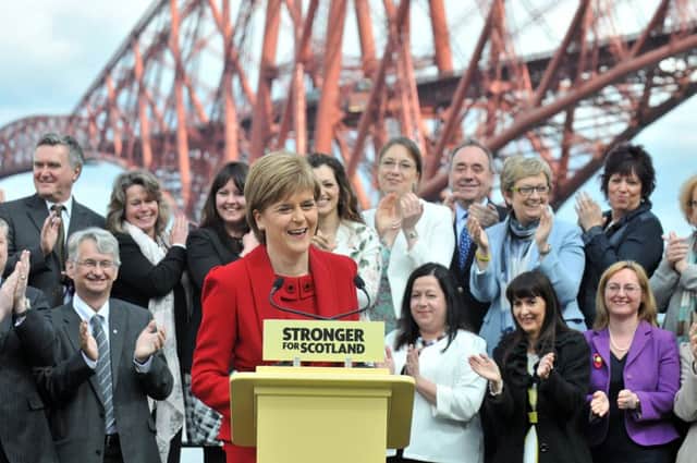 First Minister Nicola Sturgeon shows off her newly victorious SNP MPs  among them predecessor Alex Salmond. Picture: Jon Savage