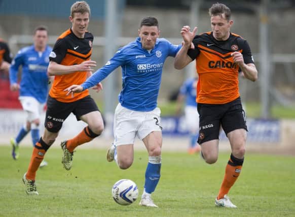 St Johnstone's Michael O'Halloran, centre, runs from Dundee United's Callum Morris. Picture: SNS