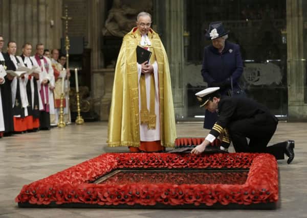 Queen Elizabeth II watches as a wreath is laid at the grave of the Unknown Warrior. Picture: PA