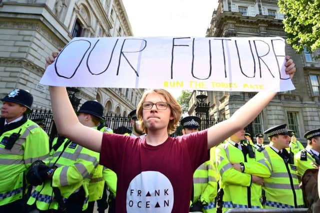 A demonstrator takes part in the anti-austerity protest outside Downing Street, in central London. Picture: PA