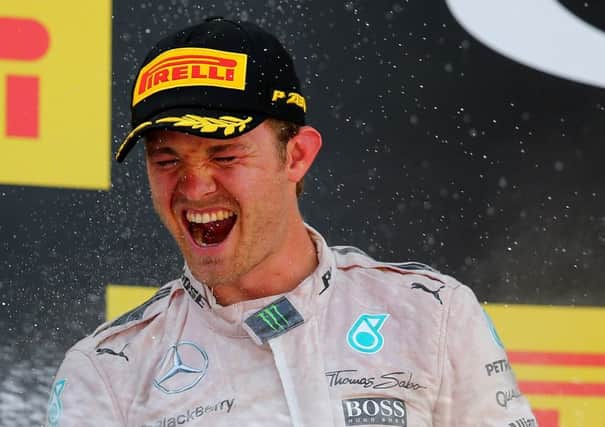 German Mercedes driver Nico Rosberg celebrates on the podium after claiming victory in Barcelona. Picture: Getty
