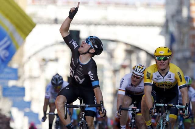 Italian Elia Viviani, left, crosses the line to win stage two of the Giro d'Italia in Genoa. Picture: Getty