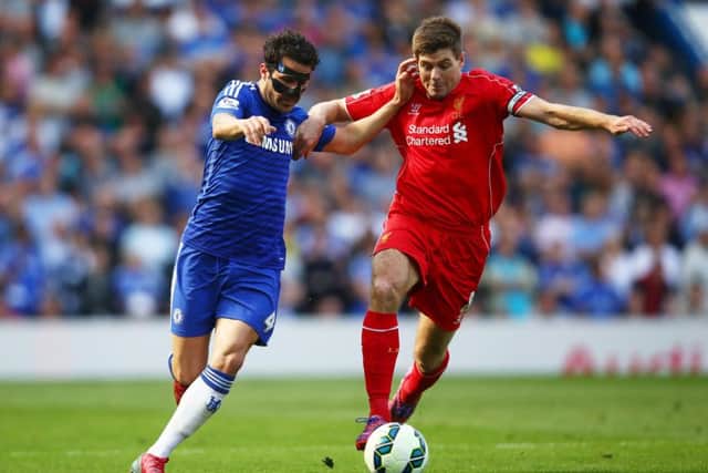 Liverpool captain Steven Gerrard battles to shake off the challenge of Chelsea's Cesc Fabregas. Picture: Getty