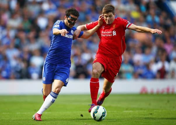 Liverpool captain Steven Gerrard battles to shake off the challenge of Chelsea's Cesc Fabregas. Picture: Getty