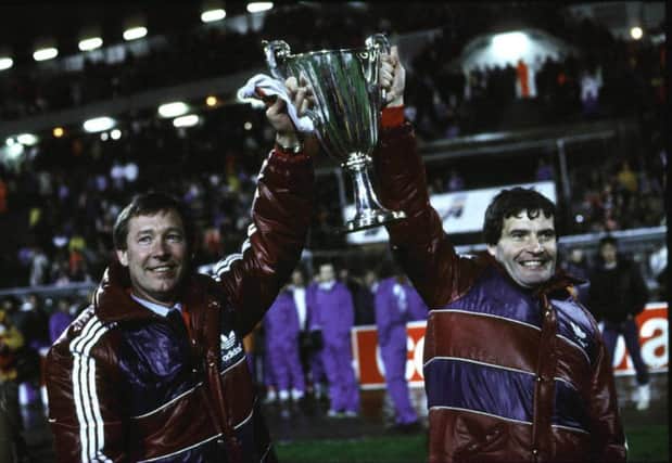 Alex Ferguson (left) and Archie Knox show off the European Cup Winners' Cup in Gothenburg in 1983. Picture: SNS