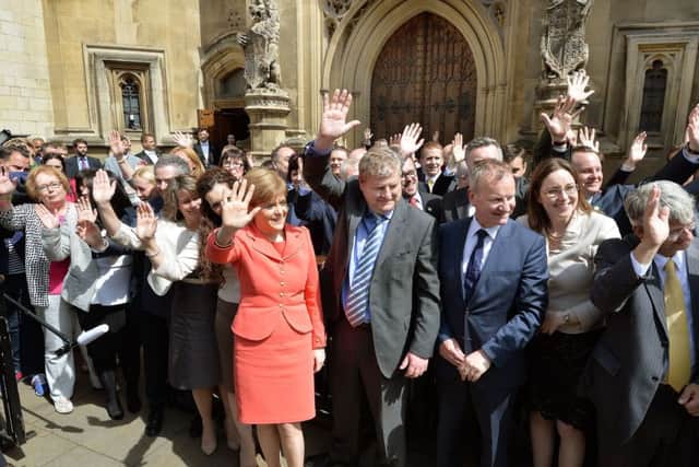 Scottish National Party leader Nicola Sturgeon stands with the SNP's 56 new members of parliament. Picture: PA