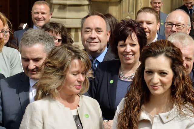 Former Scottish National Party leader Alex Salmond stands among the SNP's 56 new members of parliament. Picture: PA