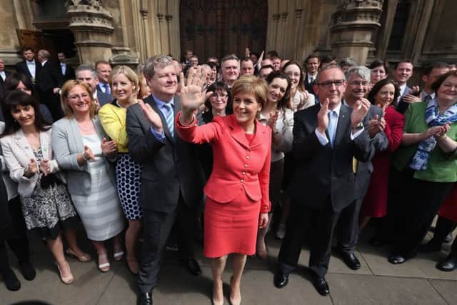 First Minister and leader of the SNP Nicola Sturgeon is joined by the newly elected SNP members of parliament outside the Houses of Parliament. Picture: Getty